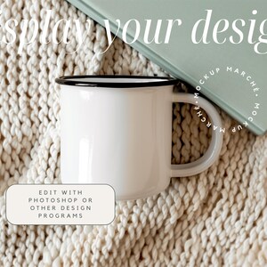 May include: White enamel mug with a black rim, sitting on a cream-colored knitted blanket. The mug is blank and ready for your design.  Edit with Photoshop or other design programs.