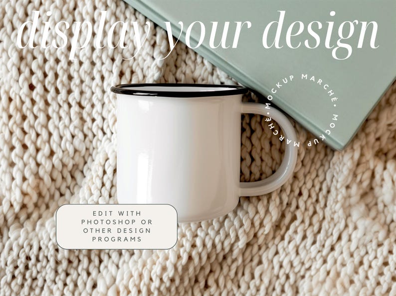 May include: White enamel mug with a black rim, sitting on a cream-colored knitted blanket. The mug is blank and ready for your design.  Edit with Photoshop or other design programs.