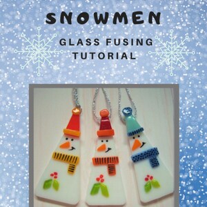 May include: Fused glass snowman ornaments with orange, red, and blue hats and scarves. Each snowman has a carrot nose, black eyes, and a smiling mouth. The ornaments are hanging on silver chains. The text "Fused Glass Snowmen" and "Glass Fusing Tutorial" is at the top.