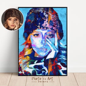 May include: A framed art print featuring a colorful, abstract portrait of a person with blue, white, and orange hues. The artwork is a close-up of a person's face, with the text "Photo to Art PRINTS" at the bottom.