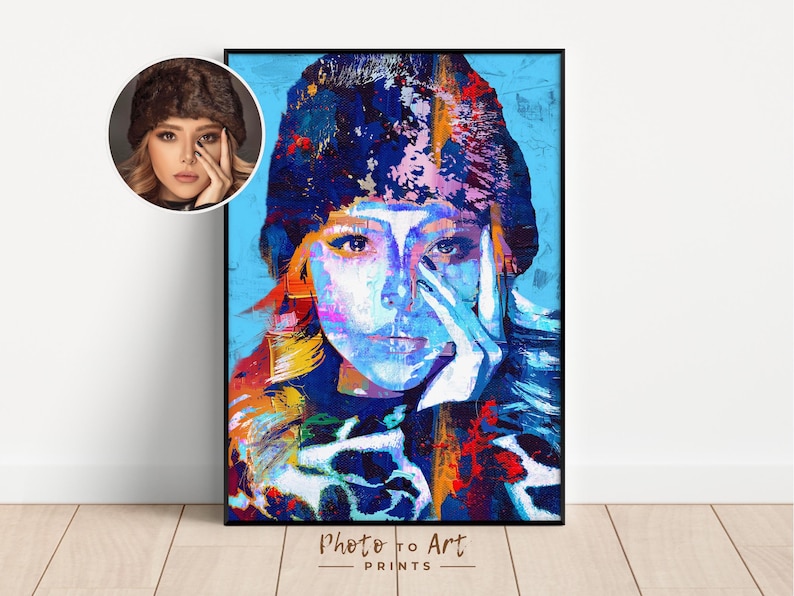 May include: A framed art print featuring a colorful, abstract portrait of a person with blue, white, and orange hues. The artwork is a close-up of a person's face, with the text "Photo to Art PRINTS" at the bottom.