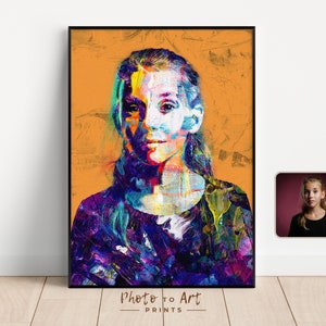 May include: A framed portrait with a vibrant, abstract painting style. The artwork features a person with colorful brushstrokes in shades of blue, purple, yellow, and green against an orange background. The text "Photo to Art PRINTS" is at the bottom.