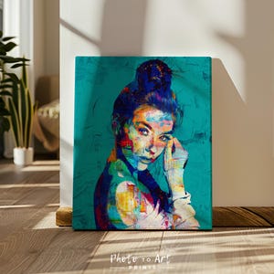 May include: A vibrant portrait print of a person with a bun, rendered in a colorful, abstract style. The artwork features a teal background and the text "Photo to Art Prints" at the bottom. The subject's face is highlighted with bold strokes of color.