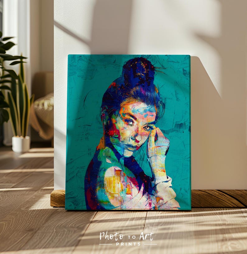 May include: A vibrant portrait print of a person with a bun, rendered in a colorful, abstract style. The artwork features a teal background and the text "Photo to Art Prints" at the bottom. The subject's face is highlighted with bold strokes of color.