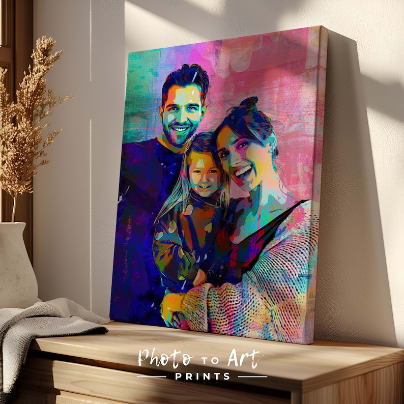 May include: A vibrant pop art style canvas print featuring a family of three. The artwork uses bold colors and brushstrokes to depict a smiling man, woman, and child. The text "Photo to Art PRINTS" is at the bottom.