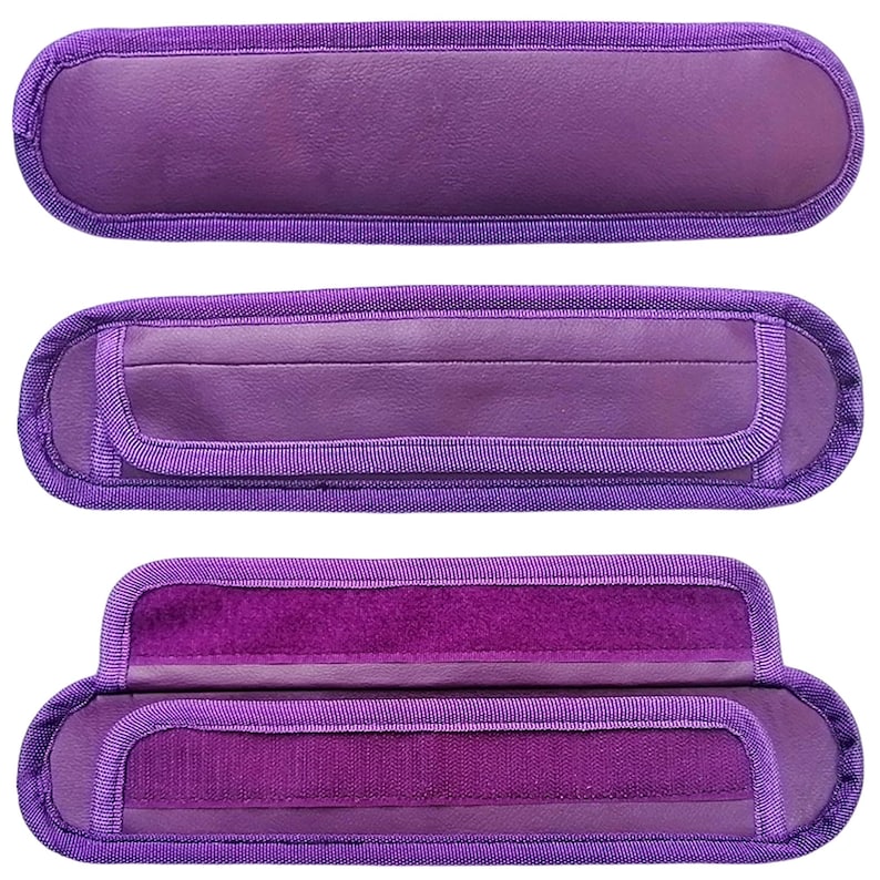 May include: Three purple fabric straps with velcro closures. The straps are designed to be used as handles for bags or other items.