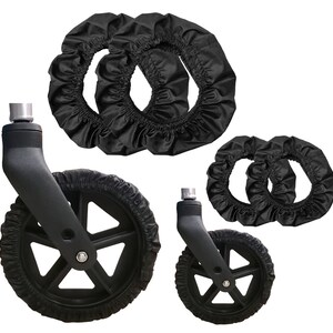 K&ouml;nnte beinhalten: Zwei schwarze Lenkrollen mit f&uuml;nf Speichen und vier passende schwarze elastische Stoffradabdeckungen. Die R&auml;der verf&uuml;gen &uuml;ber einen metallischen Befestigungszapfen an der Oberseite, und die Stoffabdeckungen sind so konzipiert, dass sie eng anliegen.