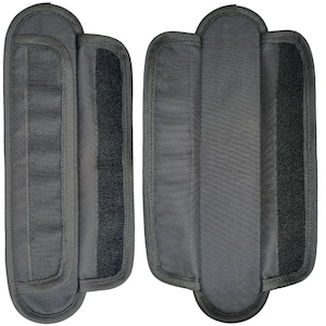 May include: Two black fabric straps with hook and loop fasteners. The straps are designed to be attached to a bag or other item.