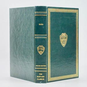 May include: A hardcover book with a dark green leather cover. The spine reads "DANA" and "THE HARVARD CLASSICS." The cover features a gold-framed emblem and gold accents. The book is a deluxe edition.
