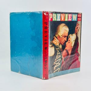 May include: A vintage 1955 "Preview" magazine. The cover features a color illustration of a man in a military uniform and a woman in a red cloak. The magazine has a blue cover and a red spine with the title "Preview 1955".