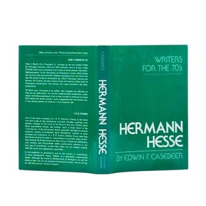May include: A hardcover book titled "Writers for the 70's" featuring the author Hermann Hesse. The book has a green cover with white text. The spine reads "Hermann Hesse" vertically. The book is published by Edwin F. Casebeer.