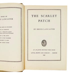 May include: An open hardcover book showing the title page for The Scarlet Patch by Bruce Lancaster, published by Little, Brown and Company in 1947. The page features a decorative border, a small oval illustration, and a list of other books.
