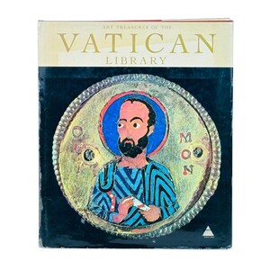 May include: A book titled "Art Treasures of the Vatican Library" with a detailed illustration of a religious figure. The illustration features a man with a beard, a blue halo, and a patterned robe. The book has a black background.