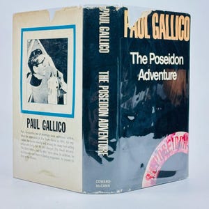 May include: A hardcover book titled "The Poseidon Adventure" by Paul Gallico. The book has a black cover with white lettering and a picture of a man on the front. The book is wrapped in clear plastic.
