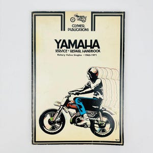 May include: A vintage Yamaha Service Repair Handbook for Rotary Valve Singles, 1963-1971. The cover features a black and white illustration of a person riding a motorcycle. The book is from Clymer Publications.