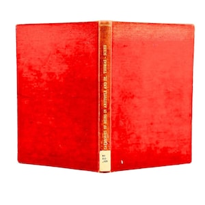 May include: A vintage book with a bright red cover, slightly worn, and a tan spine. The spine features the title "CATEGORIES OF BEING IN ARISTOTLE AND ST. THOMAS - SCHEU" in vertical text. The book is open, revealing the pages.