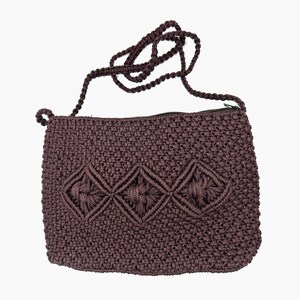 May include: A brown crocheted crossbody bag with a zipper closure and a diamond pattern. The bag has a long strap.