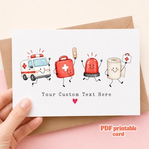 May include: A white greeting card featuring a cartoon ambulance, a red first aid kit with a bandage, a red emergency light, and a roll of gauze, all with smiling faces. The text Your Custom Text Here is printed below with a small red heart.