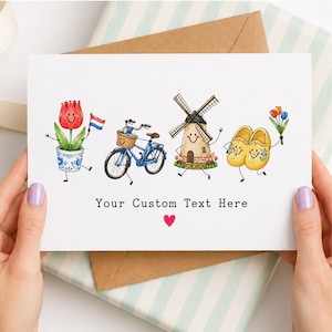 May include: A white greeting card featuring a cartoon illustration of a red tulip in a blue and white pot holding a Dutch flag, a blue bicycle with a basket, a windmill, and yellow wooden clogs holding flowers. The text reads Your Custom Text Here.