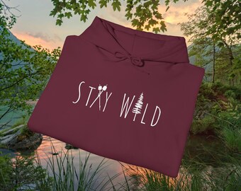 May include: Burgundy hooded sweatshirt with the text "Stay Wild" in white lettering. The text is accompanied by a small white tree and two white marshmallows on sticks.