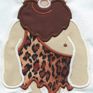May include: Embroidered cartoon caveman with a tan face, arms, and legs, a brown beard, and a leopard print loincloth. The design is outlined in white stitching. The caveman has a smiling expression.