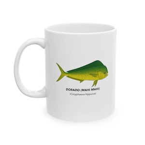 May include: White ceramic mug featuring a detailed illustration of a Dorado (Mahi Mahi) fish in shades of green and yellow. The mug includes the text "DORADO (MAHI MAHI)" and scientific name. A perfect gift for fishing enthusiasts.