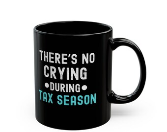 May include: Black coffee mug with white text that reads "There's no crying during tax season". The text "during" is circled in blue.