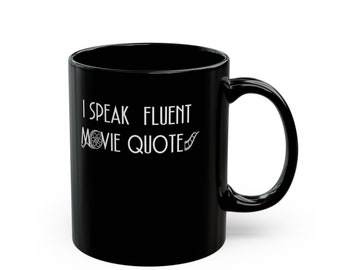 May include: Black ceramic coffee mug with a white design that says "I speak fluent movie quote" with a film reel and film strip graphic.