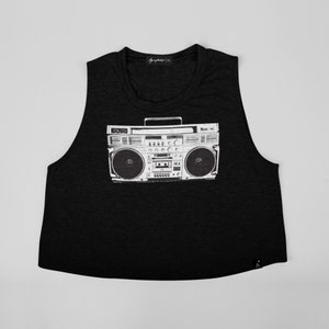 May include: Black sleeveless crop top with a graphic print of a vintage boombox.