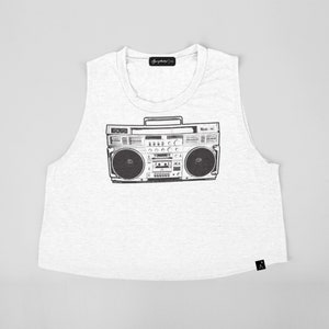 May include: White sleeveless crop top with a black and white graphic of a vintage boombox.