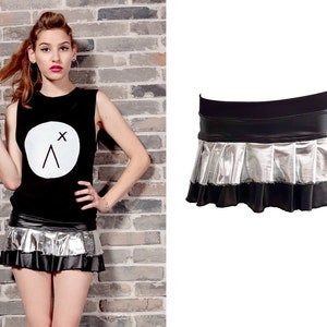 May include: A black mini skirt with a silver metallic pleated ruffle and a black waistband.