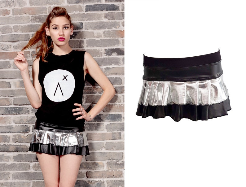 May include: A black mini skirt with a silver metallic pleated ruffle and a black waistband.