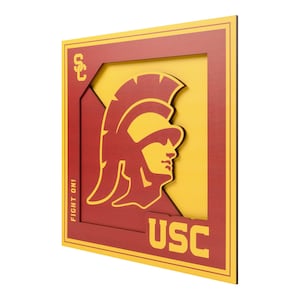 May include: A layered wooden wall art piece featuring the USC Trojans logo. The design includes a yellow Trojan helmet and the letters "USC" in a red and yellow color scheme. The words "FIGHT ON!" are also visible.