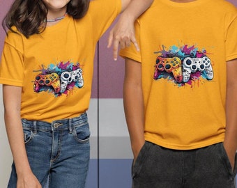May include: Two children wearing yellow t-shirts with a colorful graphic of video game controllers. The girl is wearing blue jeans and the boy is wearing black pants.