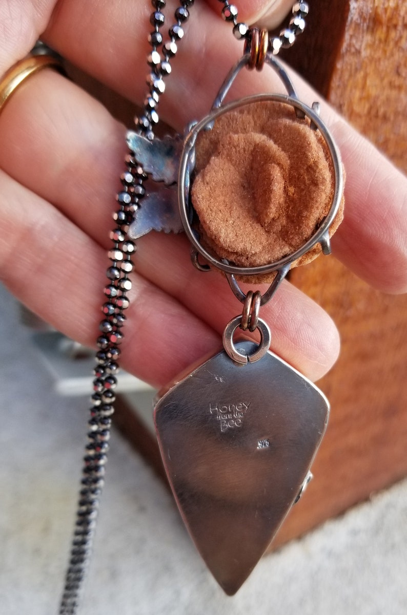 Back of artisan pendant showing basket setting for Baryte rose.