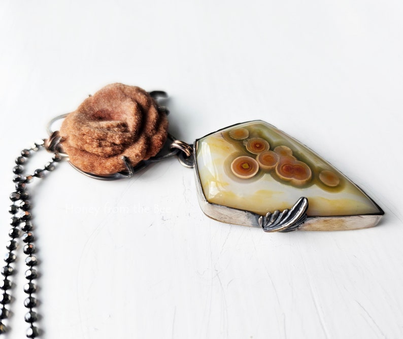 One of a kind ocean jasper art pendant in orange and cream and green.