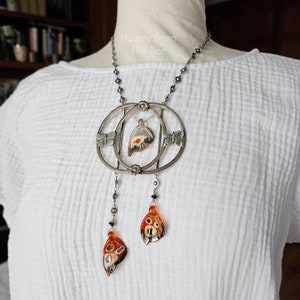 Butterfly necklace on model.