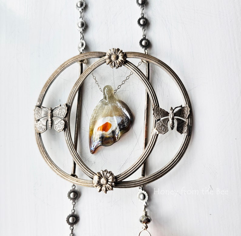 Antique buckle focal with butterflies and an art glass butterfly in grey and orange are the stars in this art necklace.