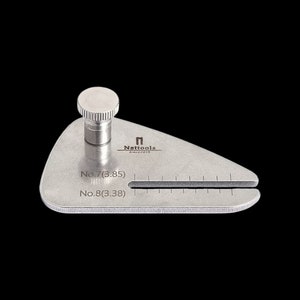 May include: A silver metal gauge with a knob on top. The gauge has two markings: No. 7 (3.85) and No. 8 (3.38). The gauge is labelled "Nattools" and "Since 2015".