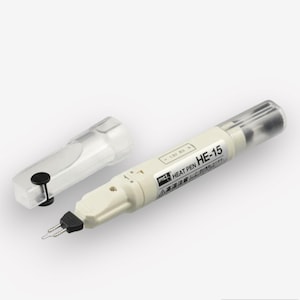 May include: A white heat pen with a black tip and a clear plastic case. The pen has the text "HEAT PEN HE-15" printed on the side.