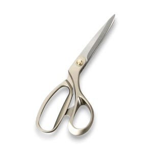 May include: Silver-toned scissors with a gold pivot. The blades are sharp and angled, and the handles have large finger holes. Designed for cutting fabric or paper. The scissors are approximately 25 cm in length.
