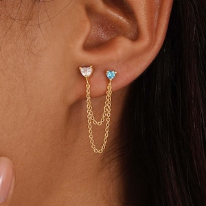 May include: A white ceramic mug with a black handle and the text "But First, Coffee" in a black, bold font. The mug is sitting on a white surface. The mug is approximately 4 inches tall.