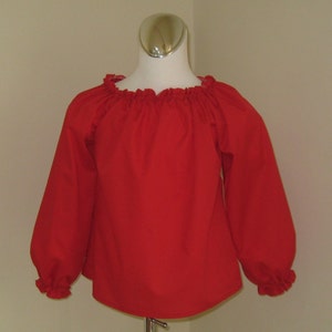 May include: A red long-sleeved blouse with a gathered neckline and ruffled cuffs.