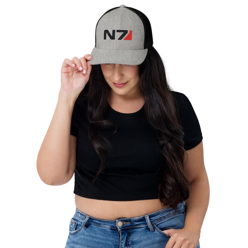 May include: A gray and black trucker hat with a black and red "N7" logo embroidered on the front.