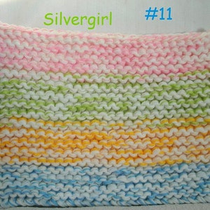 May include: Multicolored knitted fabric with stripes of pink, green, yellow, and blue. The fabric is made with a chunky yarn and has a textured look. The text "Silvergirl #11" is visible in the top right corner of the image.
