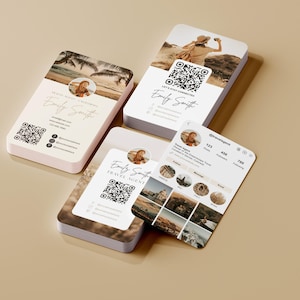 May include: A stack of business cards and a phone screen featuring a travel agent's branding. The cards display a photo, name, and QR code. The phone screen shows an Instagram profile with travel photos. The cards have a beach scene background.