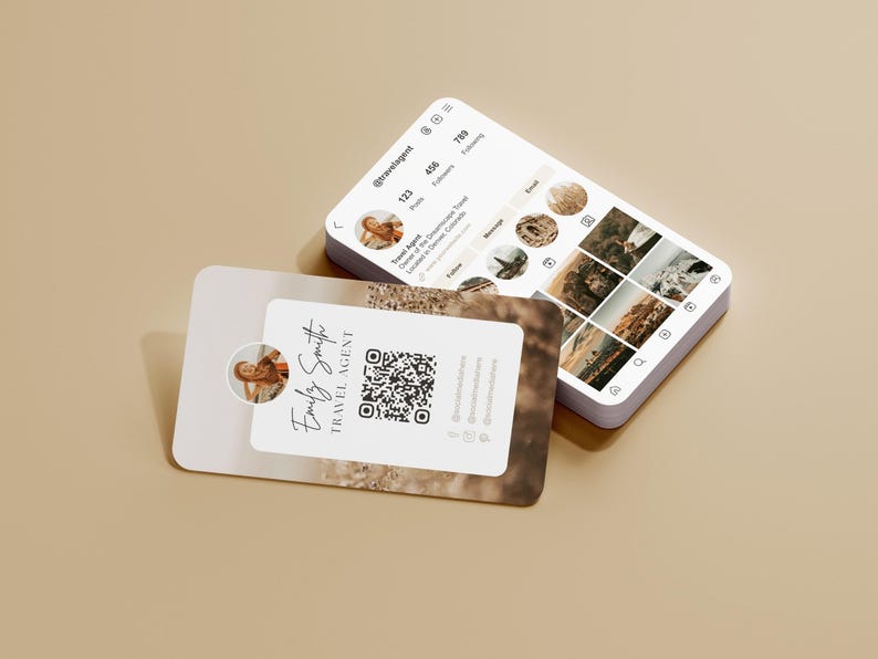 May include: A stack of white business cards and a smartphone displaying a travel agent's Instagram profile. The business card features a photo, name, and QR code. The phone shows travel photos and profile details.