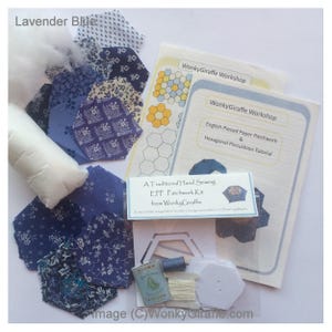 May include: A WonkyGiraffe Workshop English Pieced Paper Patchwork and Hexagonal Pincushion kit containing blue and white floral fabric hexagons, white stuffing, a tutorial booklet, thread, and paper templates for hand sewing projects.