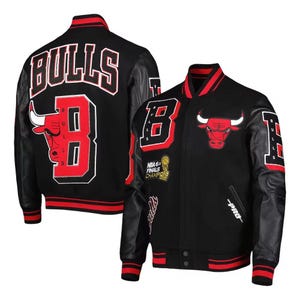 May include: A black and red varsity jacket featuring the Chicago Bulls logo and text. The back displays large white lettering reading BULLS above a red letter B with a bull graphic. The front includes a bull head emblem and championship patches.