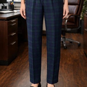 May include: Navy blue and green plaid trousers with pleats, paired with black leather loafers. The pants have a classic, tailored fit. The outfit is suitable for business or formal wear.